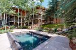 On-site amenities, include a shared outdoor heated pool, a hot tub